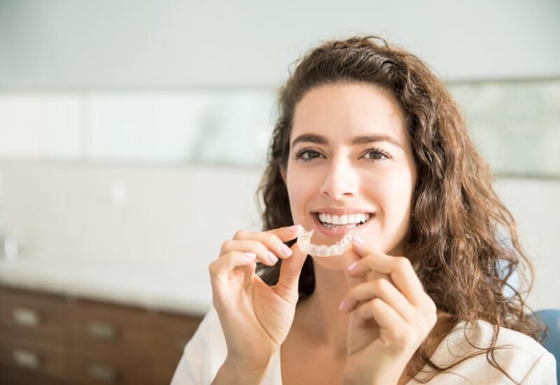 portrait beautiful patient holding orthodontic retainers dental clinic 1